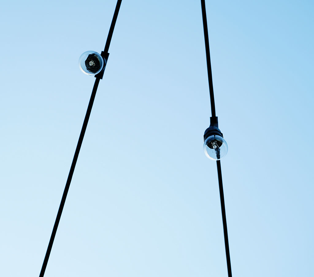Lights hang from an Airstream trailer near the Crossing magic tree